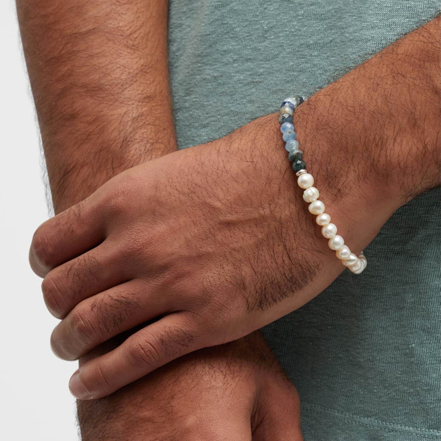 Male model wearing the Men's Freshwater Pearl and Kyanite Gemstone Split Beaded Bracelet by Jan Leslie. 