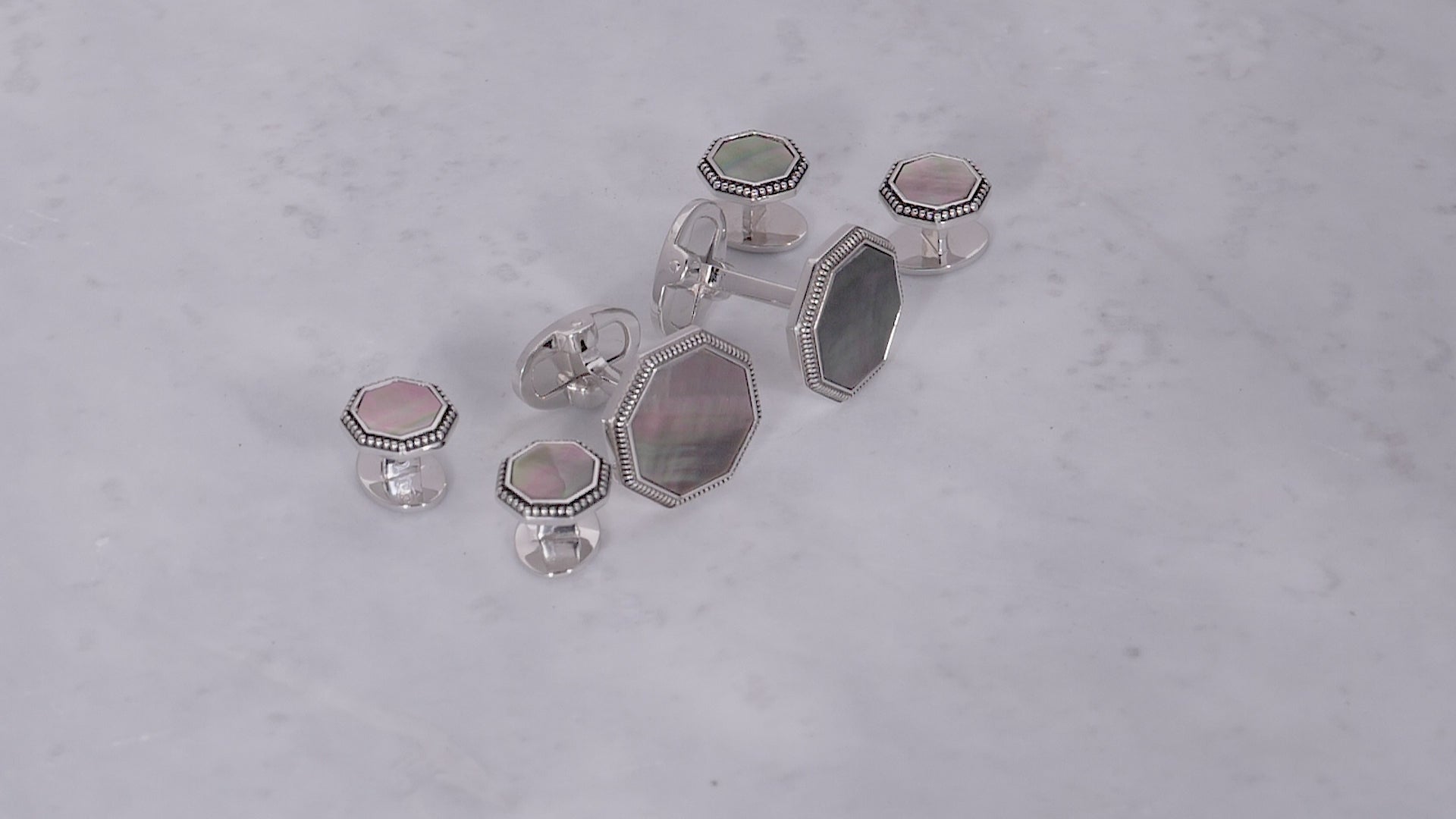 180 view of Jan Leslie's Octagon Gemstone with Antique Border Sterling Silver Cufflinks and Tuxedo Studs in grey mother of pearl. 