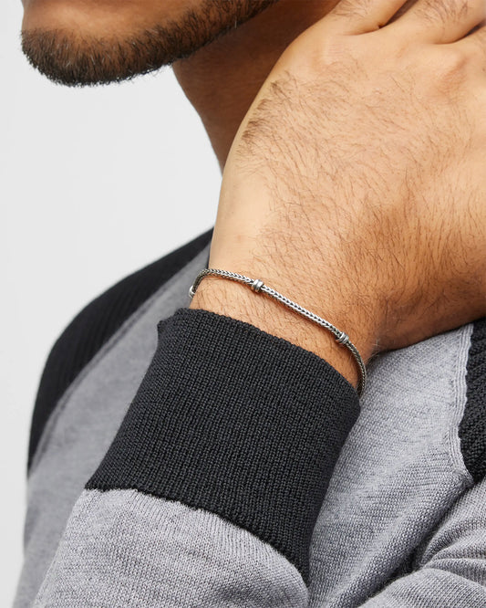 Close up of models wrist wearing Jan Leslie's Men's Sterling Silver Herringbone Bracelet. 