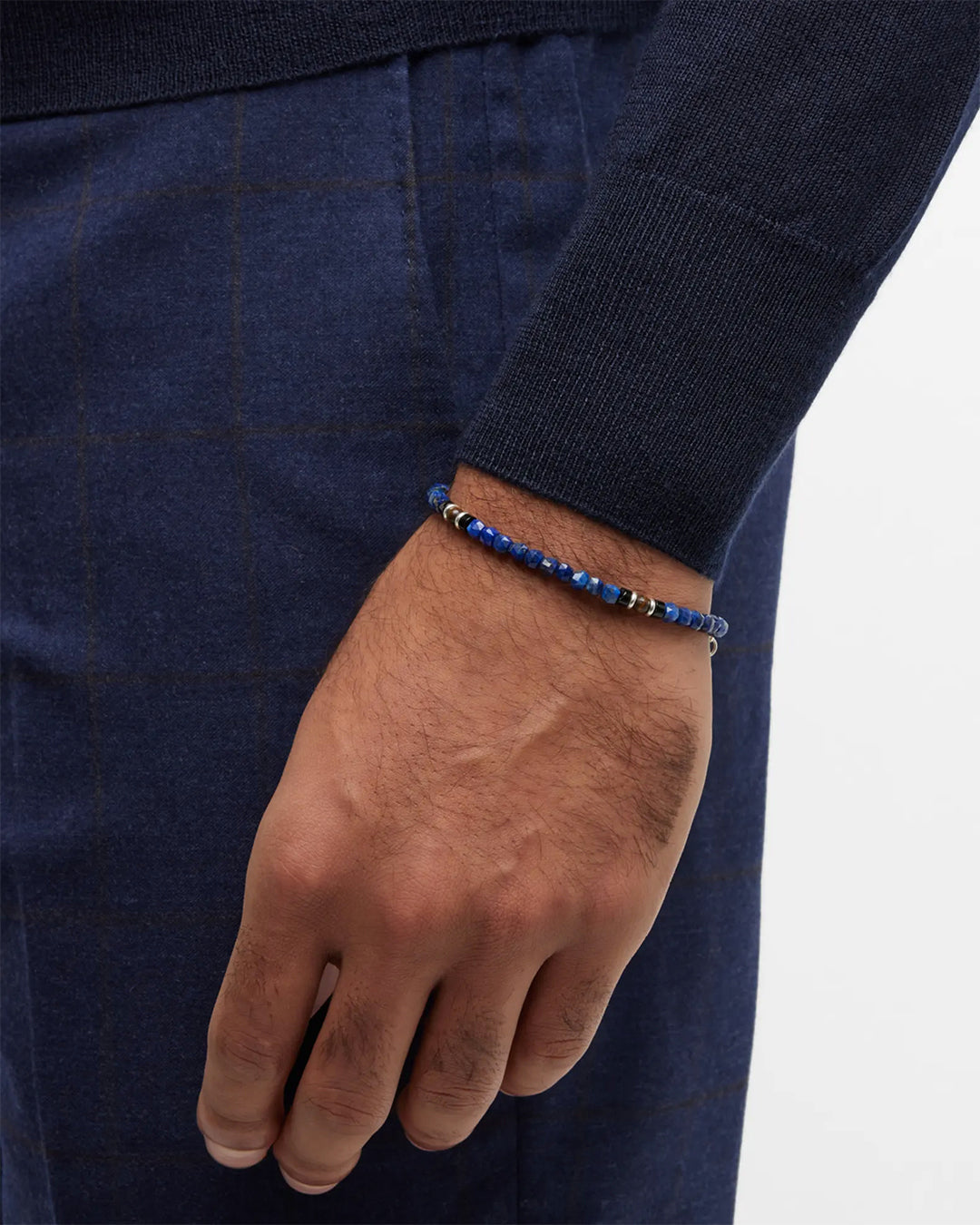 Closeup of male models wrist wearing the Lapis Bead Bracelet with Wood and Sterling Silver Spacers and Lobster Closure from Jan Leslie of NYC. 