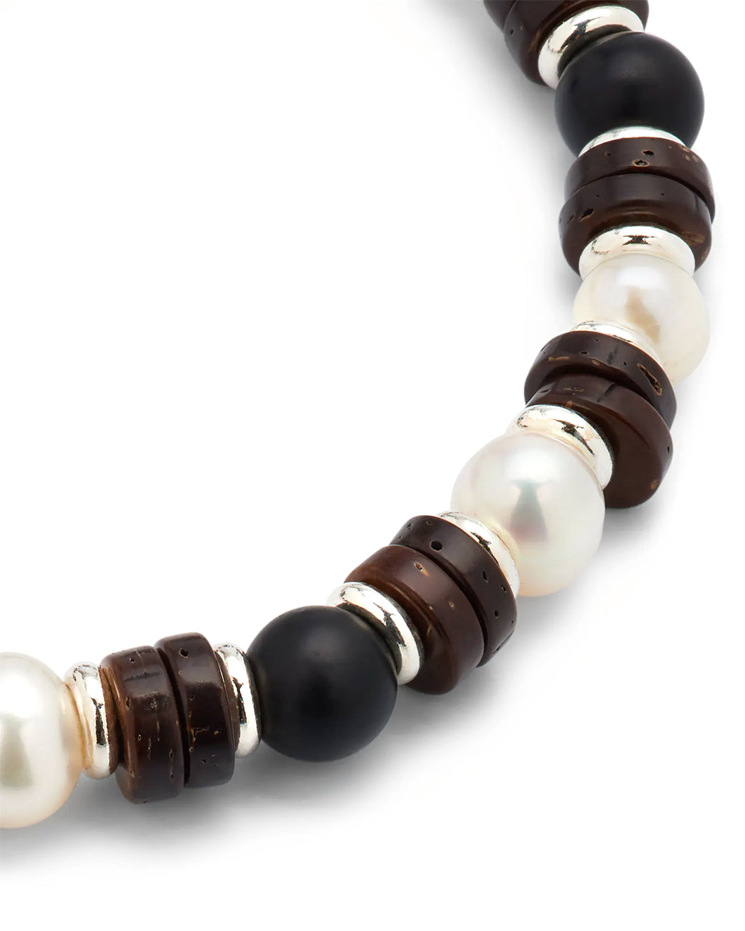 Close up picture of the black agate, and freshwater pearl beads, and wood and sterling silver spacers on the Freshwater Pearl and Black Agate Beaded Bracelet. 