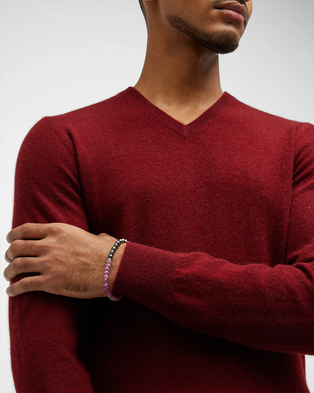 Male model wearing Jan Leslie's Men's Red Ruby and Freshwater Pearls Split Beaded Bracelet. 