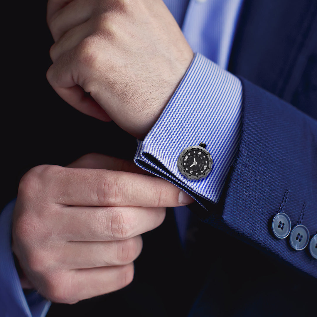 Male model wearing Miniature Face Watch Stainless Steel & Sterling Silver Cufflinks in black with gunmetal casting on a blue and white striped cuffed shirt with a blue sports coat. 