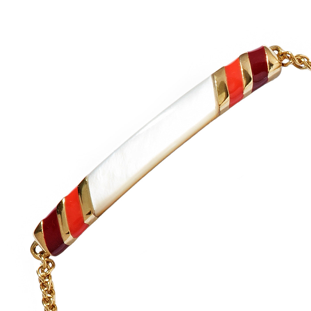 Close up of the Stripe Enamel and Shell Gemstone Adjustable 18K Gold Vermeil Bolo Sterling Silver Bracelet in red on gold. 