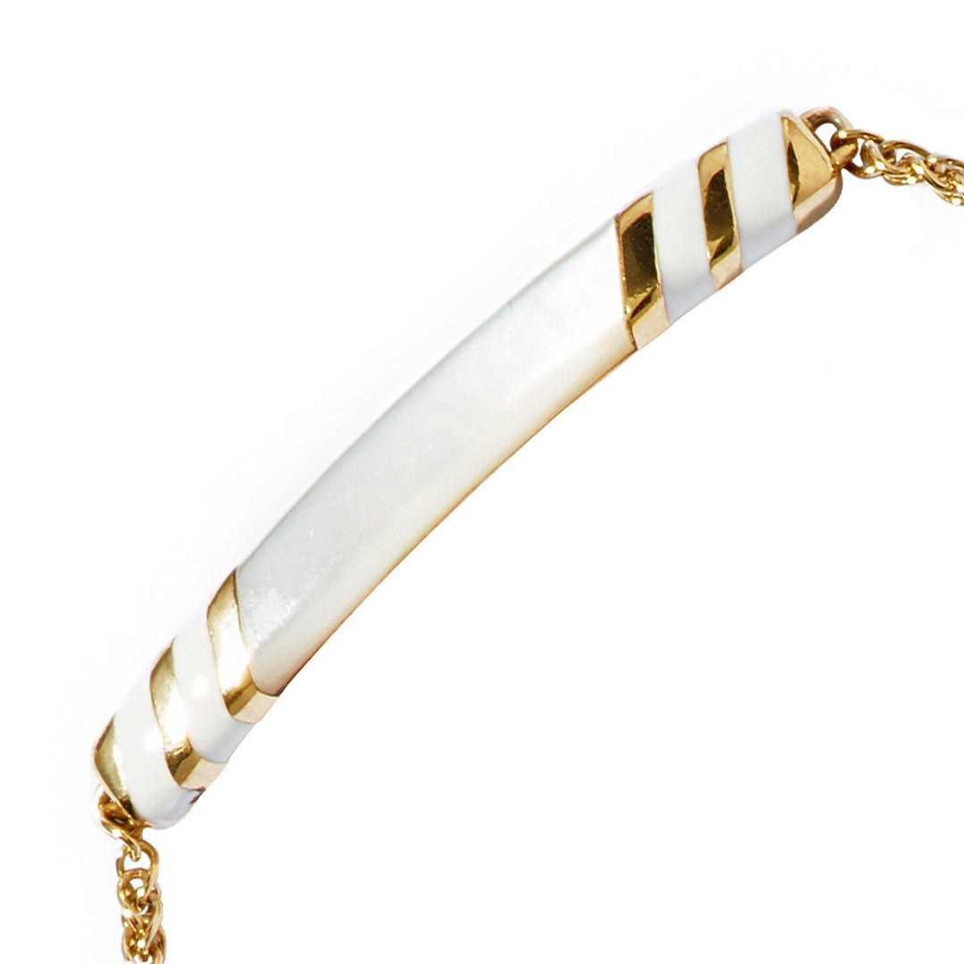 Close up of the Stripe Enamel and Shell Gemstone Adjustable 18K Gold Vermeil Bolo Sterling Silver Bracelet in white on gold I Jan Leslie Cufflinks and Accessories. 