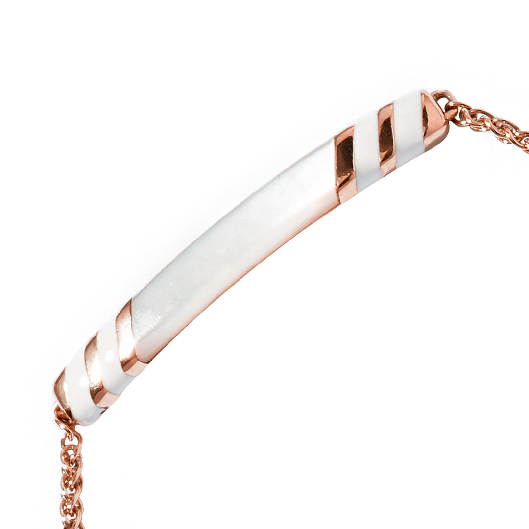 Close up of the Stripe Enamel and Shell Gemstone Adjustable 18K Gold Vermeil Bolo Sterling Silver Bracelet in white on rose gold. 