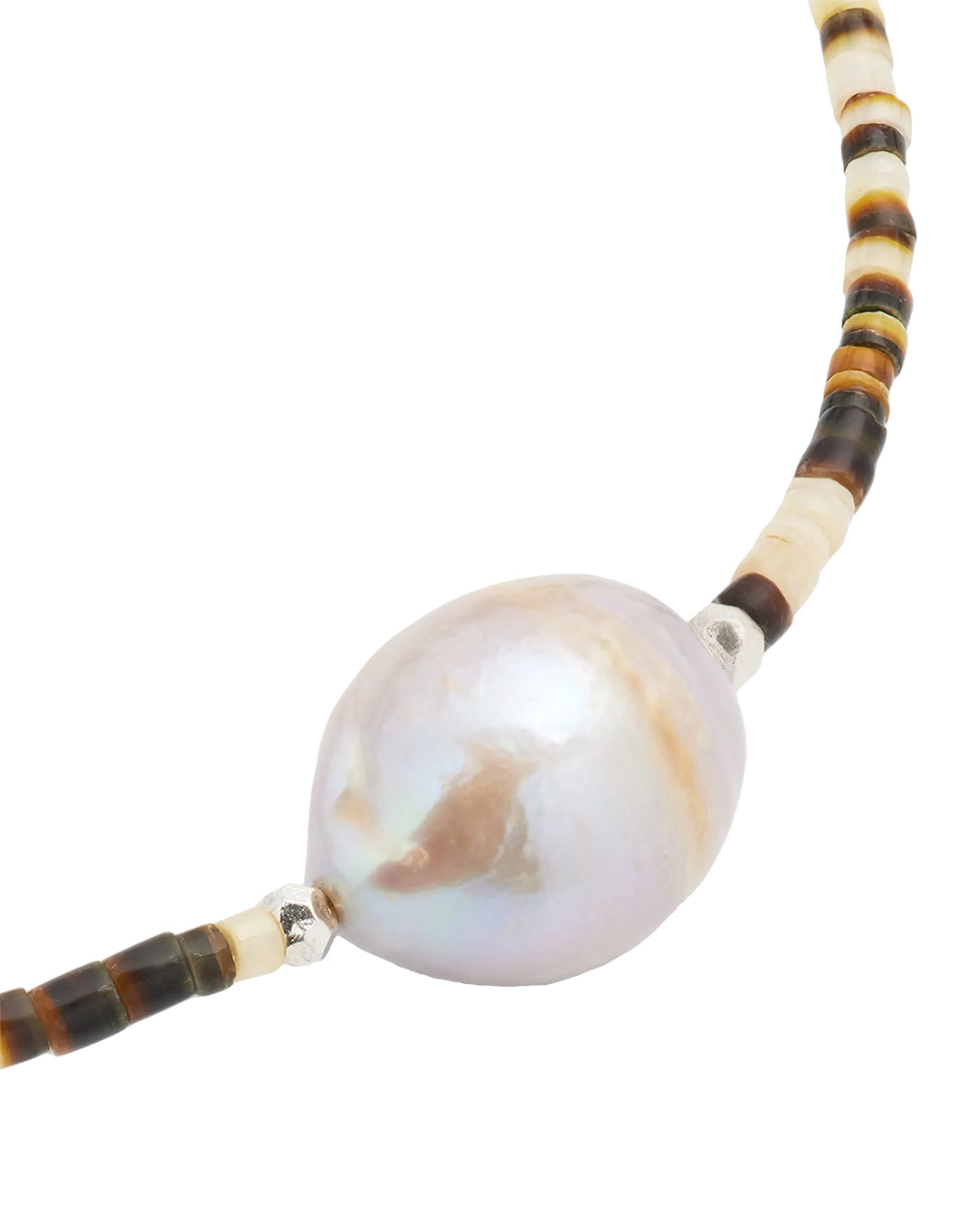 Close up of the freshwater pearl on the Shell Beaded Necklace with Freshwater Pearl Center and Sterling Silver Accents. 