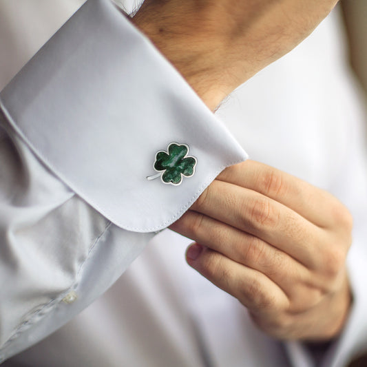 Close up of male models wrist donning the Green Onyx Four Leaf Clover Sterling Silver Cufflinks on a white cuffed shirt. 