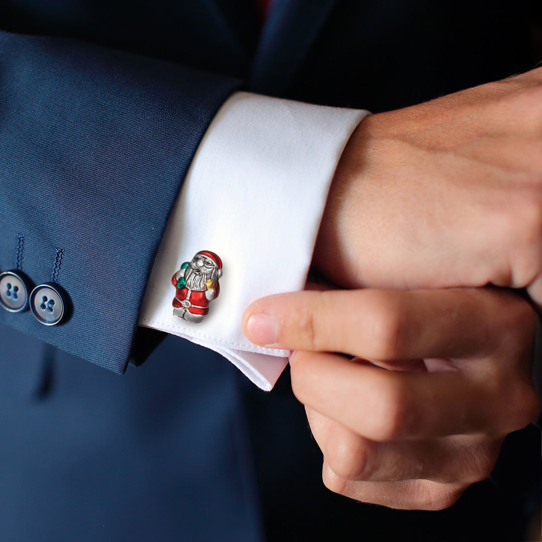 Close up of models wrist wearing the Enamel Santa Claus Sterling Silver Cufflinks on a white cuffed shirt with blue suit jacket. 