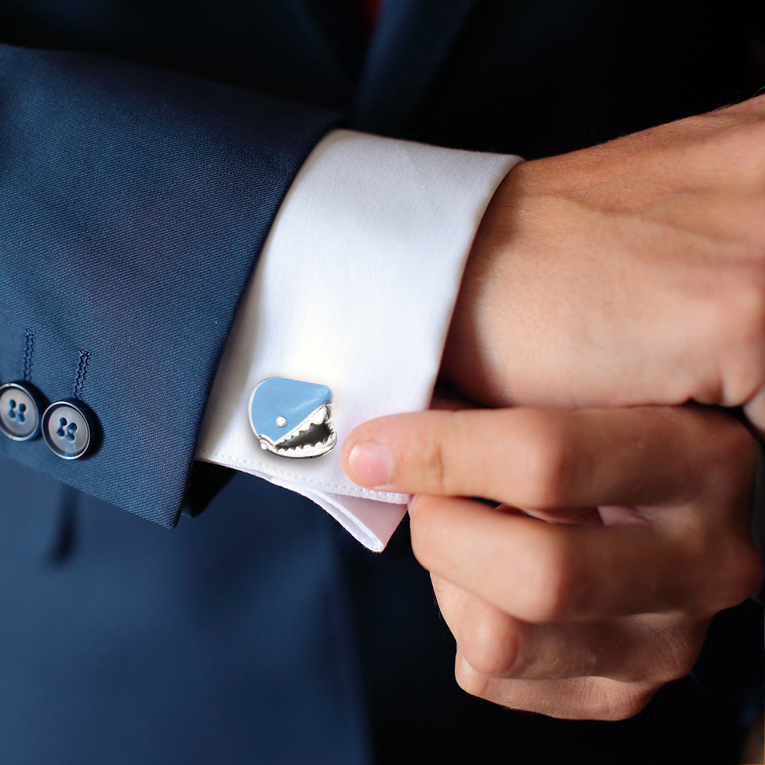 Close up of male models wrist donning the Shark with moving Jaw in Sterling Silver and hand painted enamel Cufflinks on a white cuffed shirt with navy blue sports jacket. 