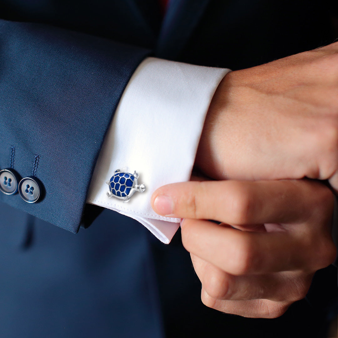 Male model wearing the Turtle with Hand-painted Enamel & Sterling Silver Cufflinks with blue enamel on a white cuffed shirt and blue sports coat. 