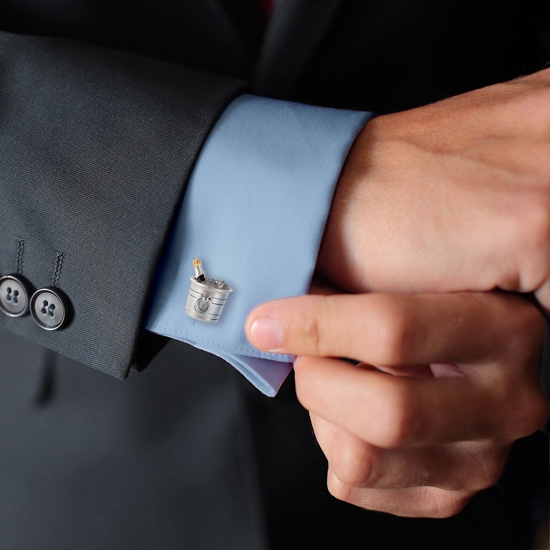 Male model wearing Champagne Bottle Sterling Silver Cufflinks on a blue cuffed shirt and black suit jacket. 