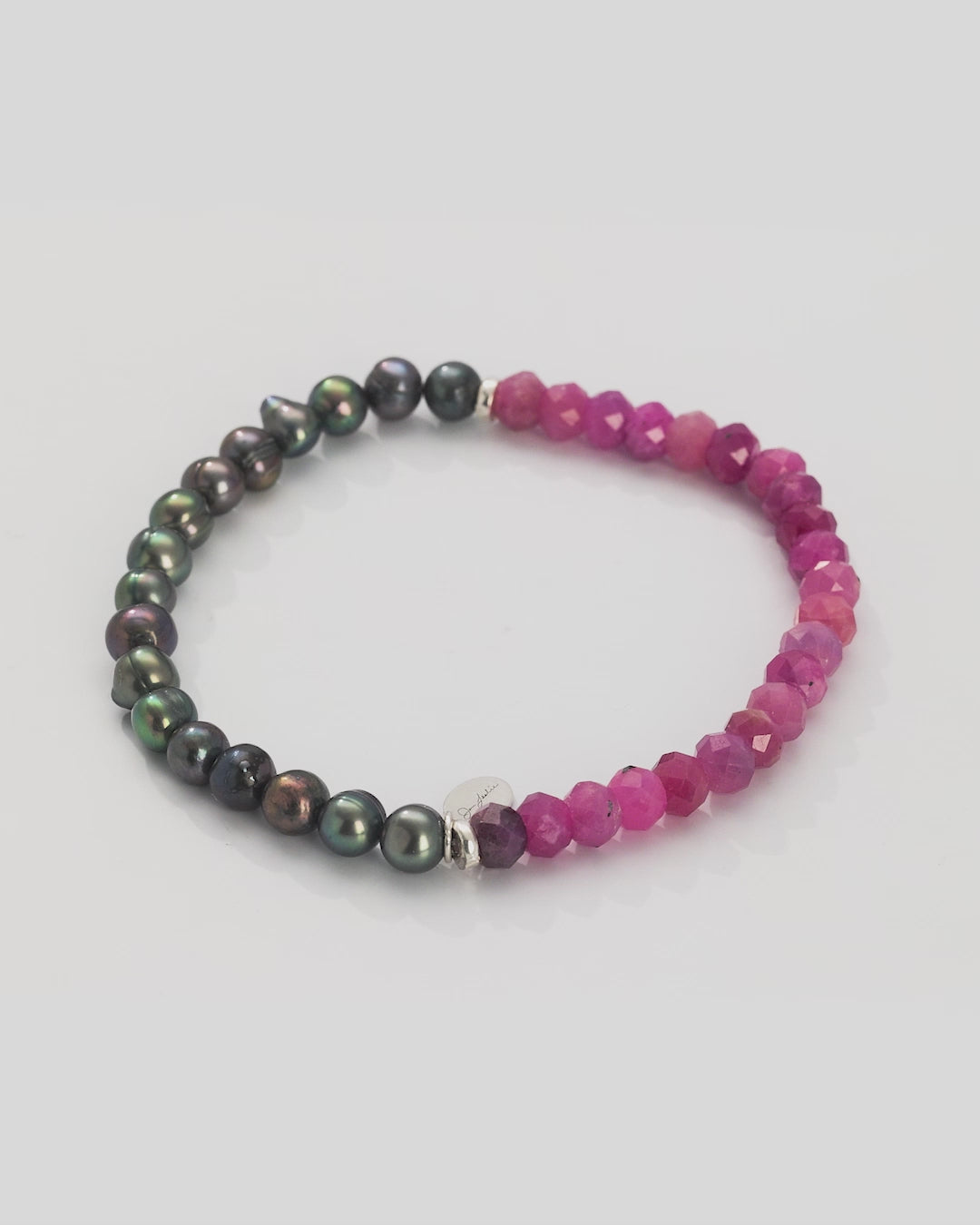 360 video of Jan Leslie's Men's Red Ruby and Freshwater Pearls Split Beaded Bracelet. Video shows full bracelet and closeup of the grey freshwater pearls. 