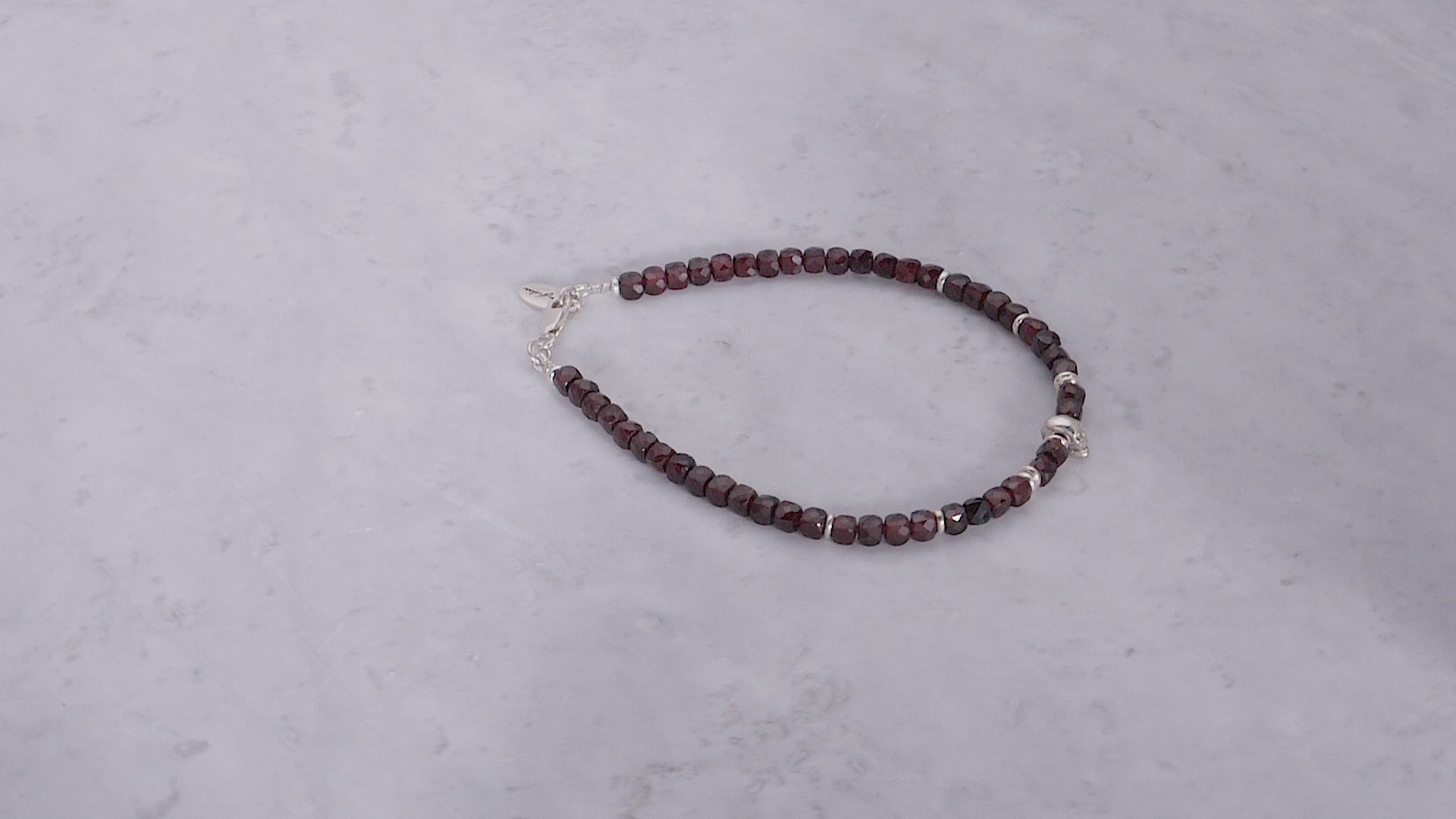 180 degree video of the Faceted Garnet Gemstone Beaded Bracelet with Sterling Silver Skull. 